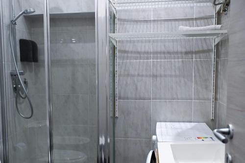 a bathroom with a shower stall and a toilet at GIKLA MAISON in Catania