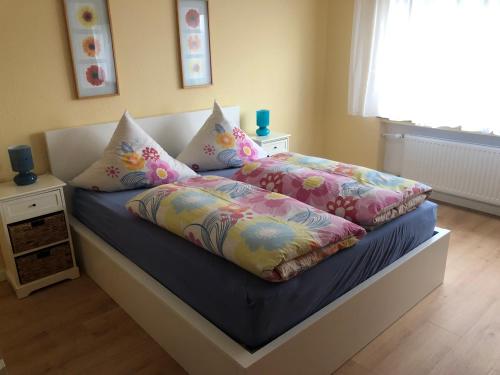 a bed with two pillows on it in a bedroom at Blick ins Grüne in Idar-Oberstein