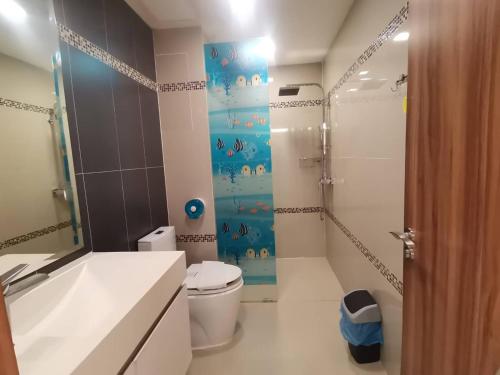 a bathroom with a white toilet and a shower at คลับรอยัล2bed in North Pattaya