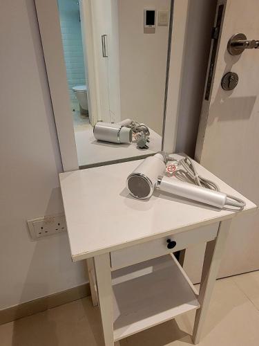 a bathroom vanity with a mirror and a sink at Family Floatie Flat with Pool & Workspace in As Sīfah