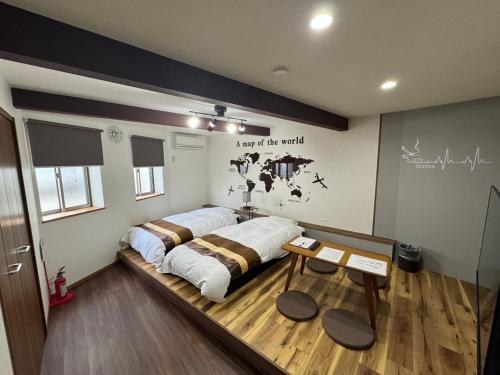 a bedroom with a bed and a table in it at Swiss 1960 in Sumoto