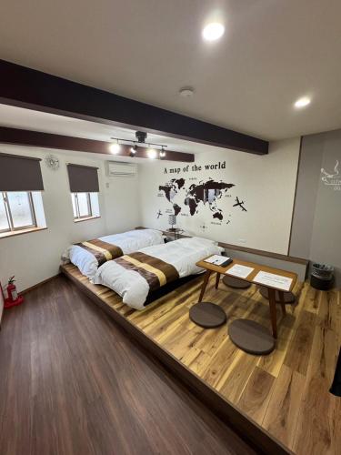 a large bed in a room with a table at Swiss 1960 in Sumoto