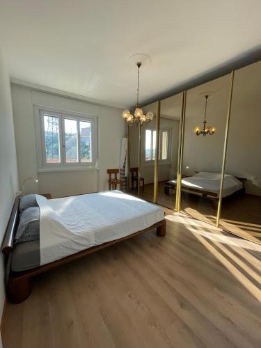 a large bedroom with a large bed and a mirror at Casa Nora in Trieste