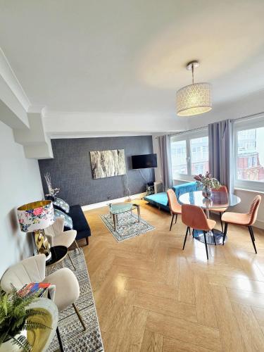 a living room with a couch and a table at Luxury Beachfront Apartment Brighton Centre in Brighton & Hove