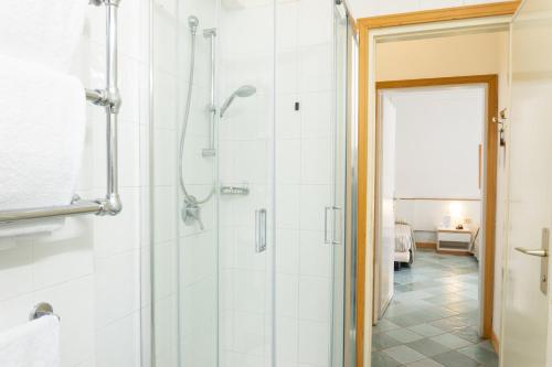 a bathroom with a shower with a glass door at Hotel L'Approdo in Castiglione della Pescaia