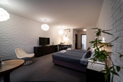 a bedroom with a bed and a table and a tv at Trybunalska in Lublin
