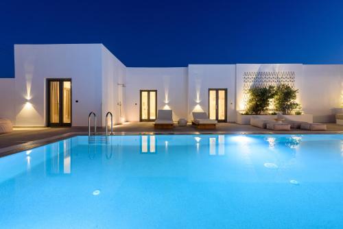 a swimming pool in a villa at night at Noble Pearl Villas Paros in Santa Maria