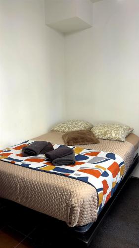 un letto con un piumone e dei cuscini sopra di LoVe 3 a Cap d'Agde