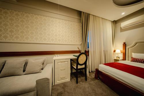 a hotel room with a bed and a desk at 49 Park Villa in Belgrade