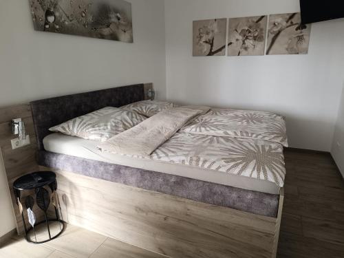 a bed with a wooden frame in a bedroom at Ferienwohnung Albel in Velden am Wörthersee