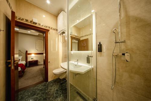 a bathroom with a toilet and a sink and a shower at 49 Park Villa in Belgrade