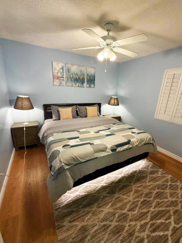a bedroom with a large bed with a ceiling fan at Spacious 3BR Luxury Villa Gated Parking Near Dodger St DTLA in Los Angeles