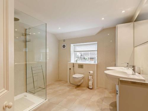 a bathroom with a shower and a toilet and a sink at 4 Bed in Tavistock oc-92491 in Bulkworthy