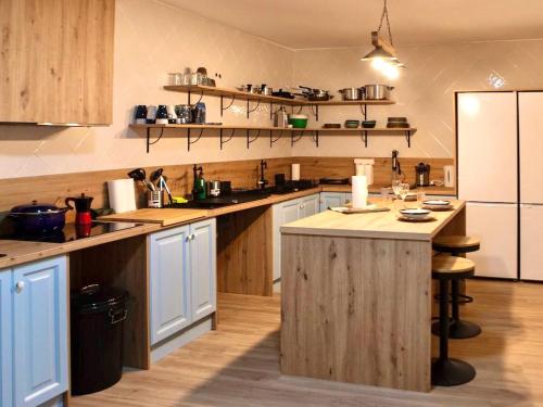 a large kitchen with wooden counters and a large island at Posada de la Luna in Granada