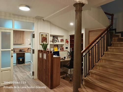 a home office with a staircase and a desk at Posada de la Luna in Granada