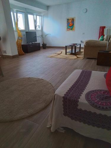 a living room with a bed and a couch at Casa Rafter Abades in Abades