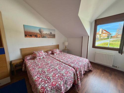 a bedroom with a bed and a large window at Villa de Pedrena - 32801 in Pedreña
