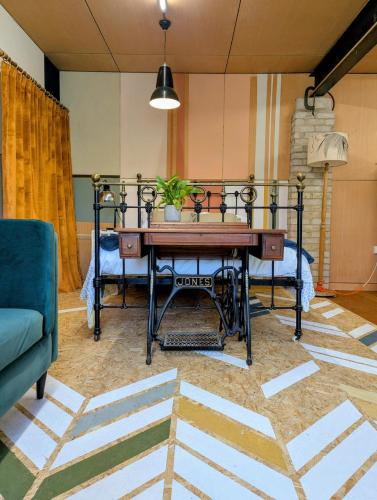a living room with a table and a couch at Woodside Studio in Hassocks