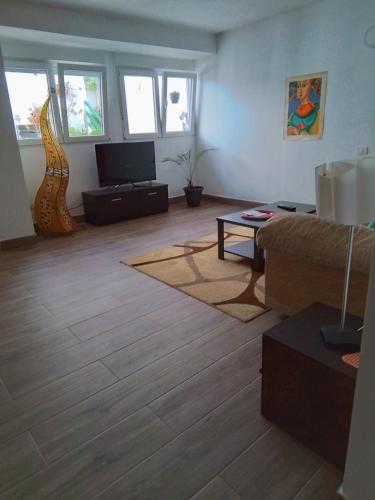 a living room with a couch and a tv at Casa Rafter Abades in Abades
