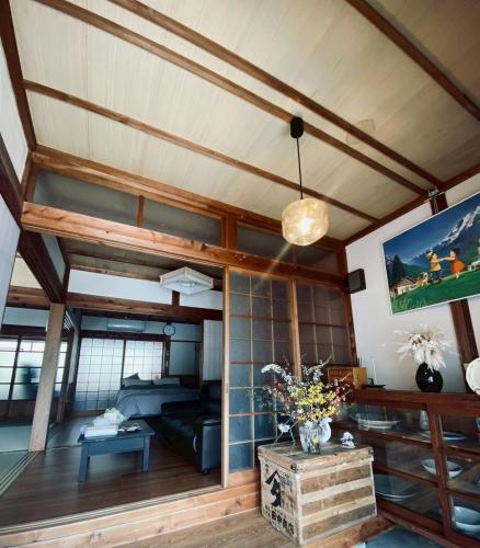 a living room with a couch and a table at おやど 瀬名 in Tanabe