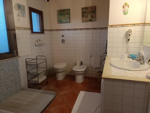 a bathroom with a toilet and a sink at Punto de Vista B&B Makari in San Vito lo Capo