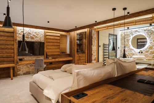 a living room with a couch and a table at Flora Boutique Hotel in Borovets
