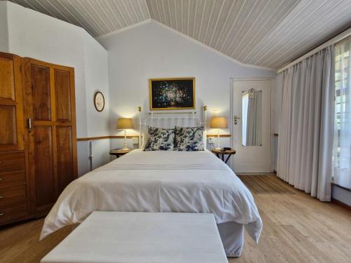 a bedroom with a large bed in a room at Old Oak Guest House in Bellville