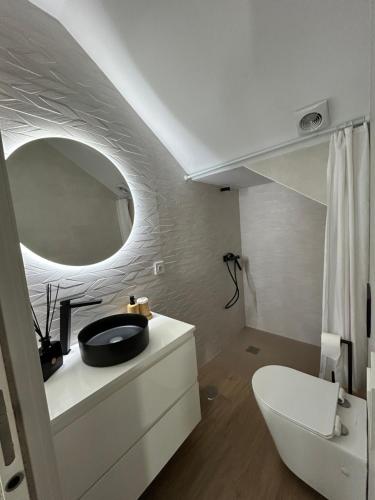 a bathroom with a sink and a mirror at Center Luxury Chalet Mazagón in Mazagón