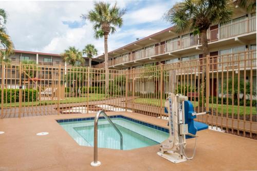 a swimming pool with a slide in a building at Red Roof Inn PLUS+ & Suites Naples Downtown-5th Ave S in Naples