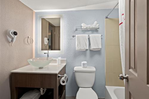 a bathroom with a sink and a toilet at Red Roof Inn PLUS+ & Suites Naples Downtown-5th Ave S in Naples
