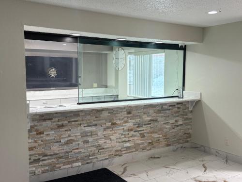 a kitchen with a large mirror on the wall at Red Roof Inn & Suites Hammond, IN in Hammond