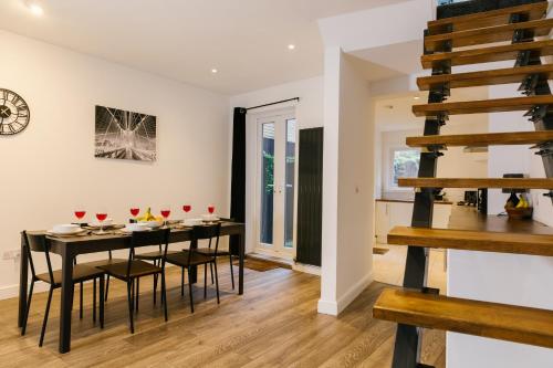 a kitchen and dining room with a table and chairs at Charming Coastal Retreat in BN2 in Brighton & Hove