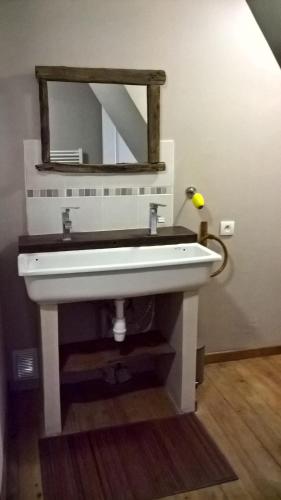 a bathroom with a white sink and a mirror at Gîte de Bontemps in Saint-Vincent-de-Cosse