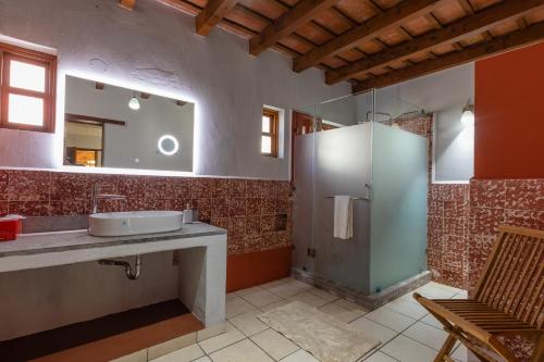 a bathroom with a sink and a mirror at Casa Historica Atitlán in Panajachel