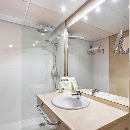 a white bathroom with a sink and a mirror at B&B HOTEL Cartagena Cartagonova in Cartagena