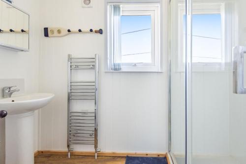 a bathroom with a ladder next to a sink and a shower at Violet in Heacham