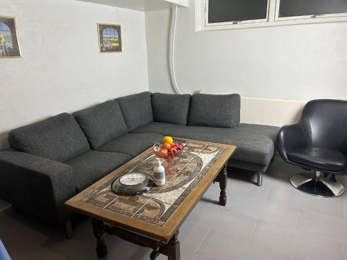 a living room with a couch and a coffee table at Basement Apartment in Villa in Odense