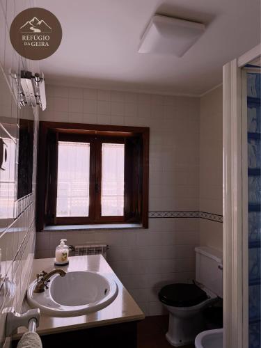 a bathroom with a sink and a toilet at Refúgio da Geira in Campo do Gerês