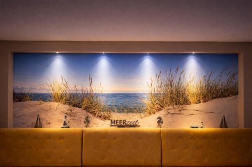 a wall with a picture of the ocean on it at Hotel zur Traube in Kühlungsborn