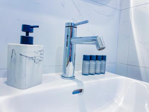 a bathroom sink with a faucet and toothpaste at Bel appartement à Royat in Royat