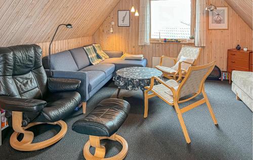 a living room with a couch and chairs and a table at Two-Bedroom Holiday Home In Rudkobing in Spodsbjerg
