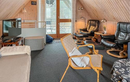 a living room with chairs and a table at Two-Bedroom Holiday Home In Rudkobing in Spodsbjerg