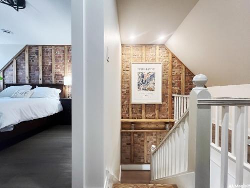 a bedroom with a bed and a staircase at Trendy Home Spacious Backyard Historic Walkerville in Windsor