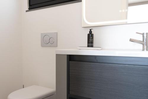 a bathroom with a sink and a mirror at Elísio do Mar by LovelyStay in Prazeres