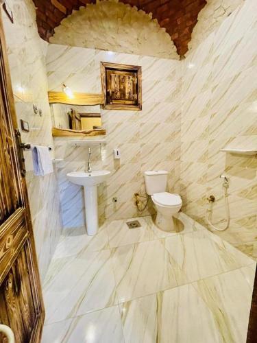 a bathroom with a toilet and a sink at The Green Mirage free pickup in Siwa