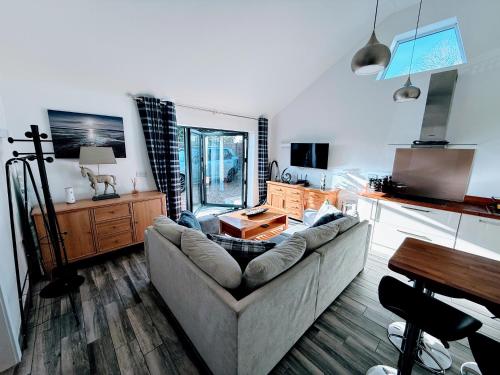 a living room with a couch and a table at Ferndown Holiday Let in Ferndown