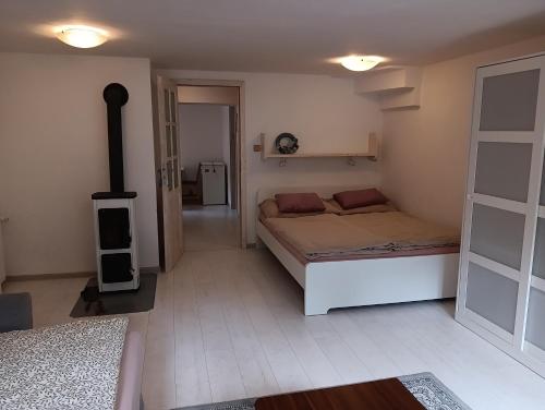 a bedroom with a bed and a stove in it at Pravda in Loket