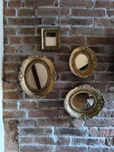 a brick wall with four pictures on it at Apartment By the River in Niš