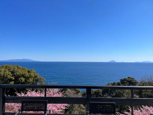 a view of the ocean from a balcony at UMI SORA VILLA 伊豆河津 in Kawazu