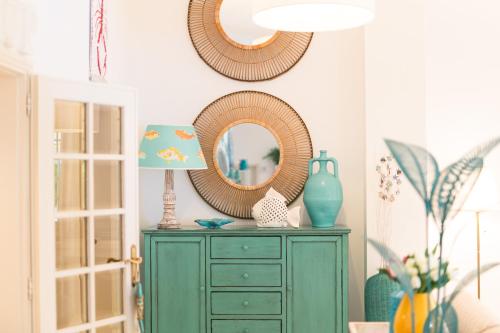 a green dresser with a mirror and a lamp at Hotel La Pineta Al Mare in Forte dei Marmi